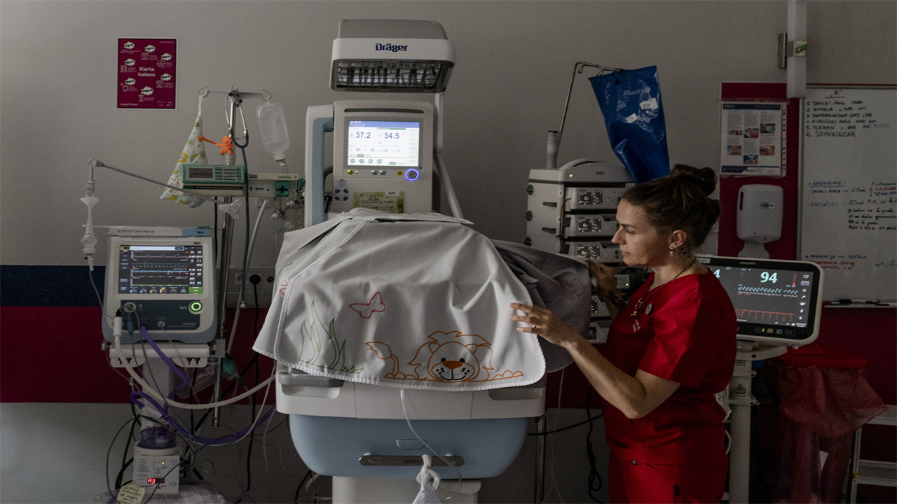 Dr. Gizela Jagielska, a gynecologist and the deputy director of the public hospital in Olesnica, Poland, looks into the incubator of a newborn, on July 28, 2023. 