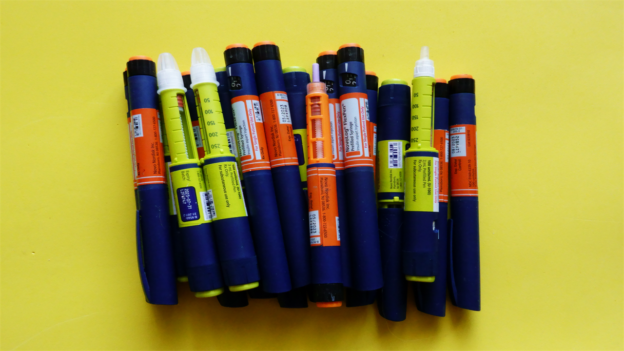 Still life of Tresiba insulin pens on yellow